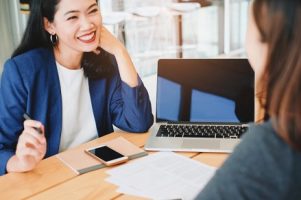 two-young-businesswomen-meeting-and-taking-about-working-process-at-the-office_1356-66