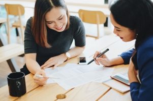 two-young-businesswomen-meeting-and-working-process-at-the-office_1356-63