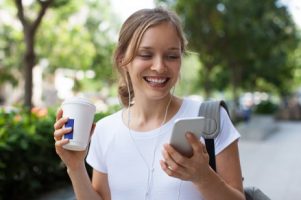 smiling-young-woman-having-video-call-outdoors_1262-6731