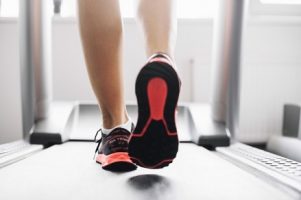 woman-in-sports-shoes-running-on-treadmill_23-2147688019